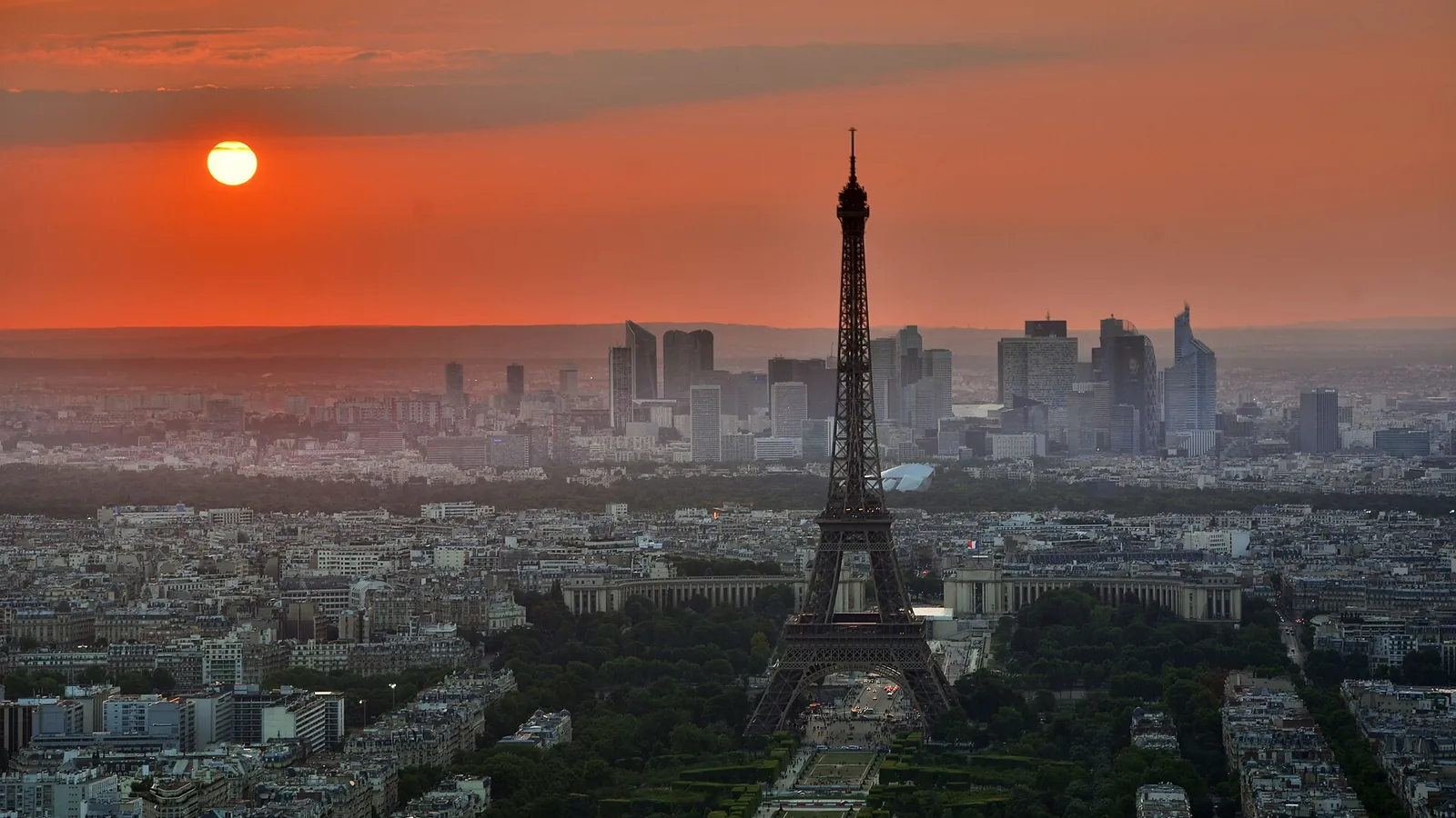 The Eiffel Tower rising above the Paris rooftops at sunset