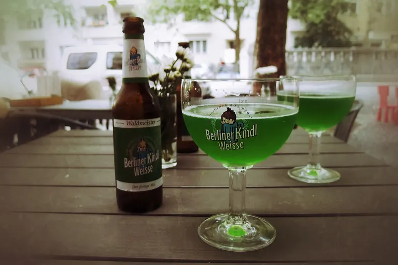 A glass of Berliner Weisse beer with fruit syrup