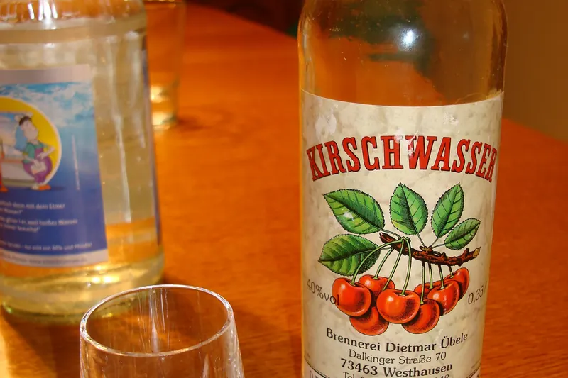A bottle and glass of Kirschwasser cherry brandy