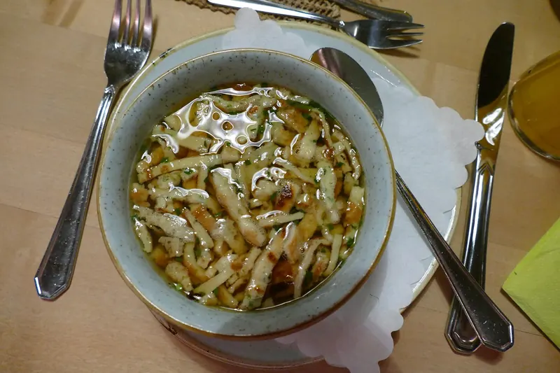 A bowl of Flädlesuppe with pancake strips