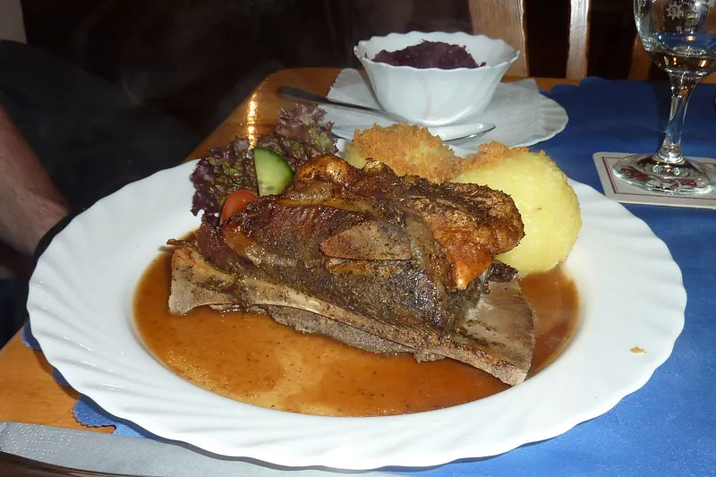 Schäufele, roasted pork shoulder, served with a bread dumpling and red cabbage