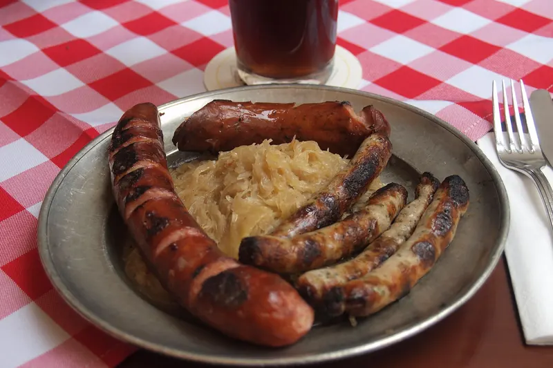 A plate of small grilled bratwurst sausages