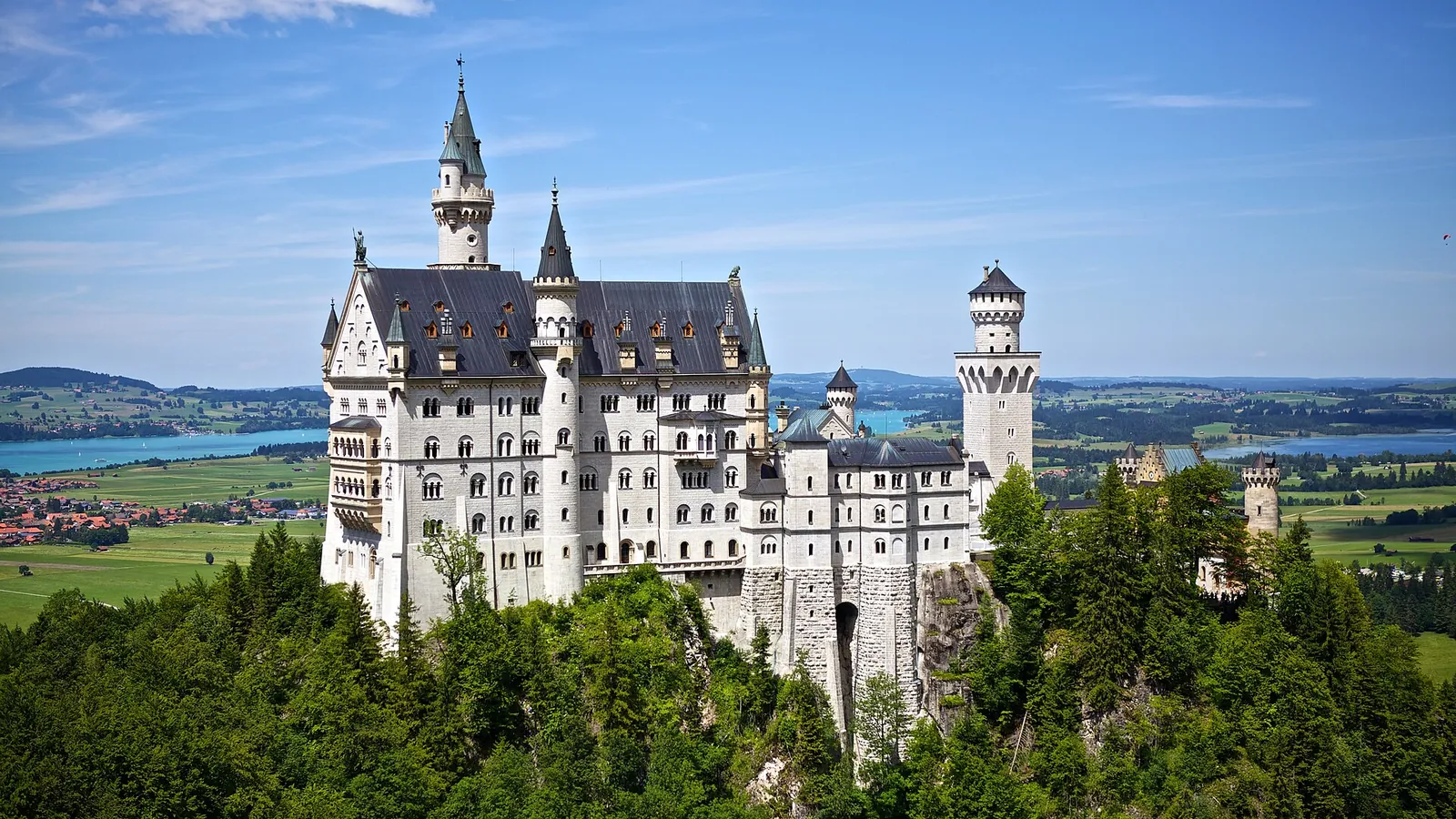 Neuschwanstein Castle rising from the forest above the Bavarian countryside