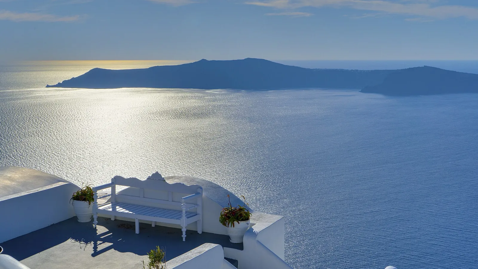 Santorini's whitewashed villages above the volcanic caldera at sunset