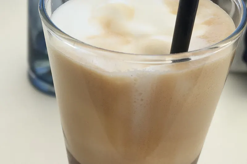 A glass of Greek frappé, a cold whipped coffee
