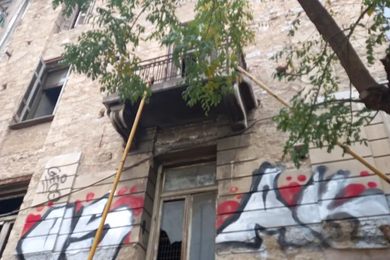 Large-scale street art on a building in central Athens
