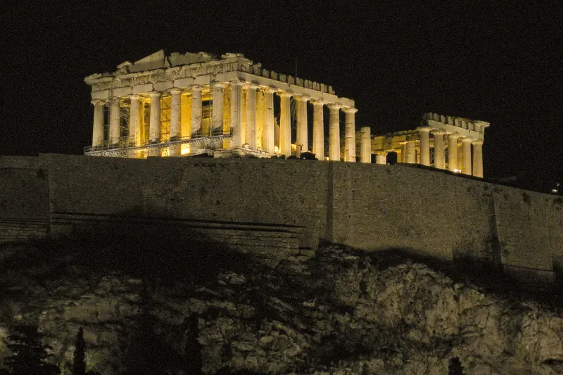 The Acropolis and Parthenon floodlit above Athens at dusk