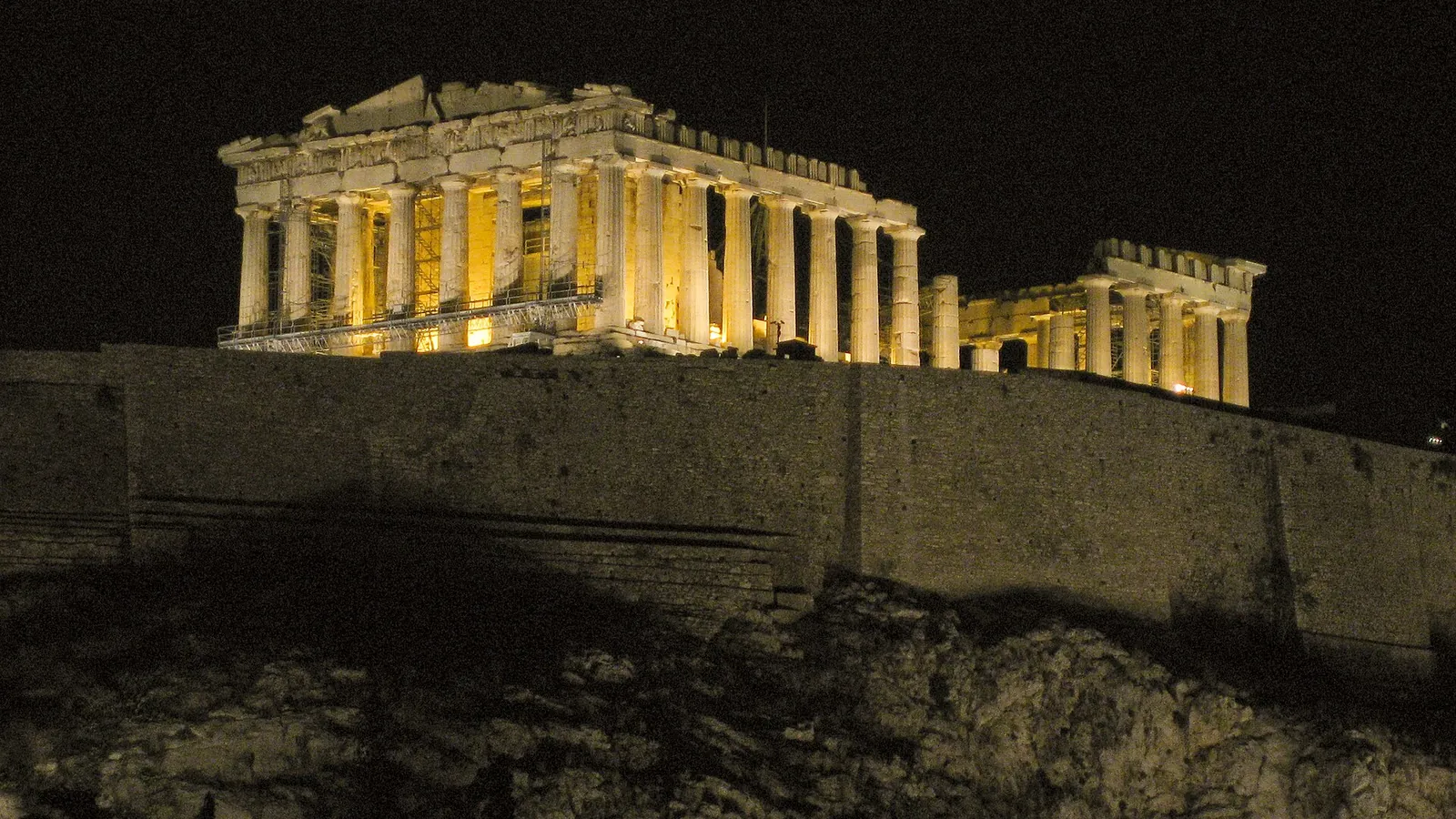 The Acropolis and Parthenon floodlit above Athens at dusk