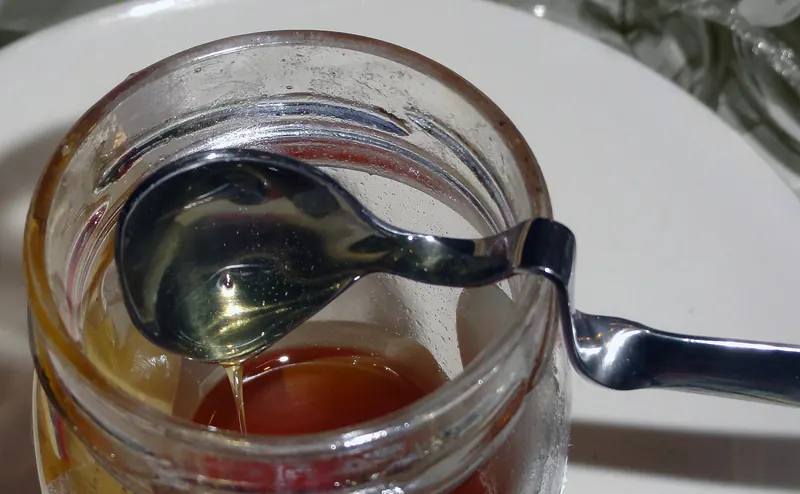 Honey drizzled from a spoon