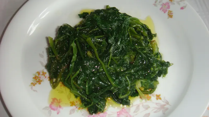 Boiled wild greens (horta) dressed with olive oil and lemon