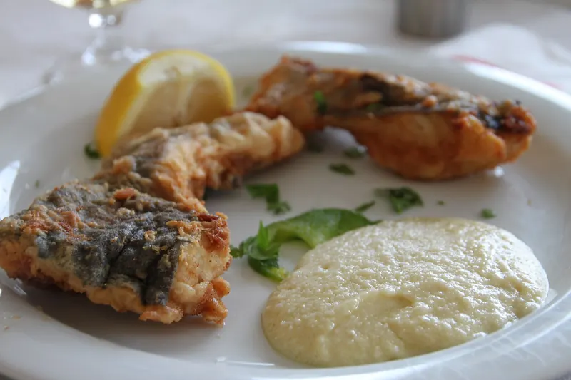 Fried salt cod served with garlic dip