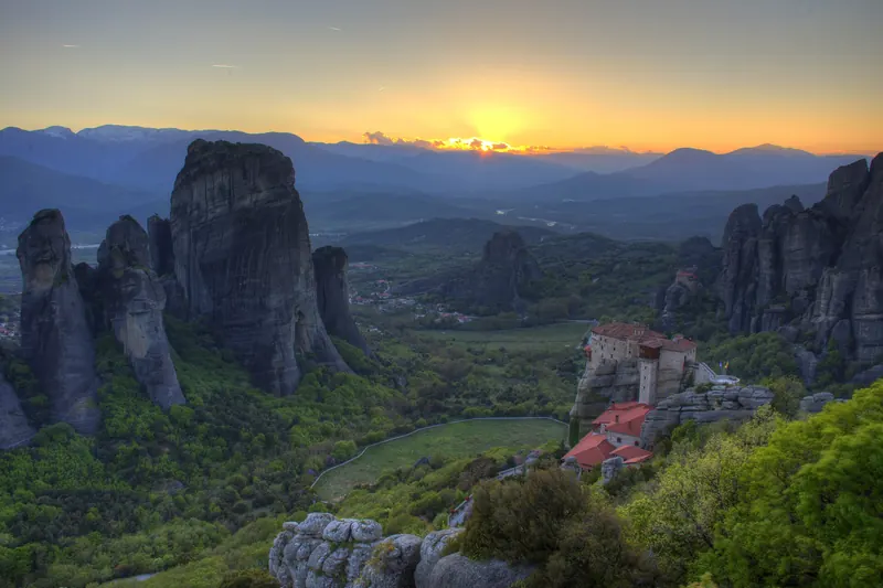 Sunset light over Meteora's rock pillars
