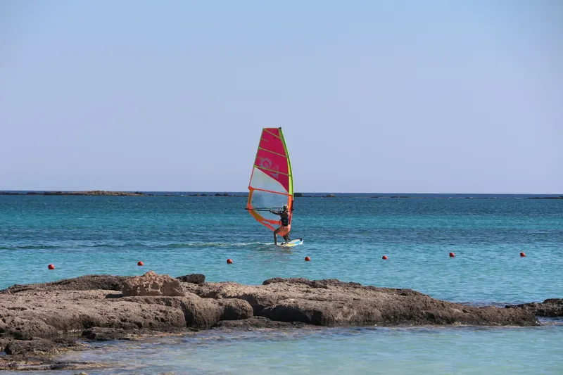 A windsurfer on a Greek island beach