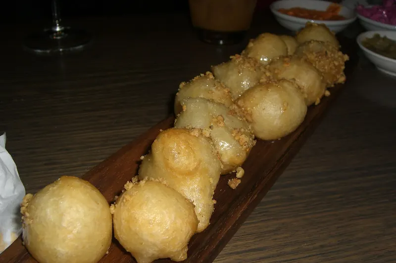 Loukoumades, honey-soaked fried dough puffs with walnuts