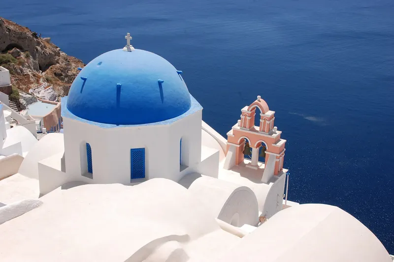 A blue-domed church in Oia, the classic sunset viewpoint