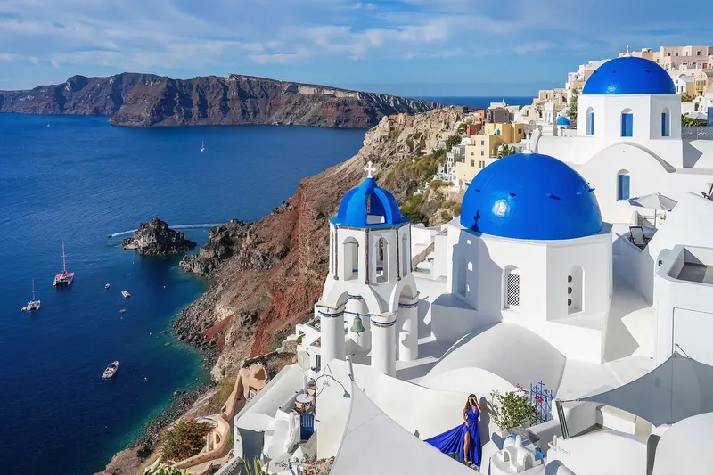 Oia's whitewashed cave houses and blue-domed churches above Santorini's caldera