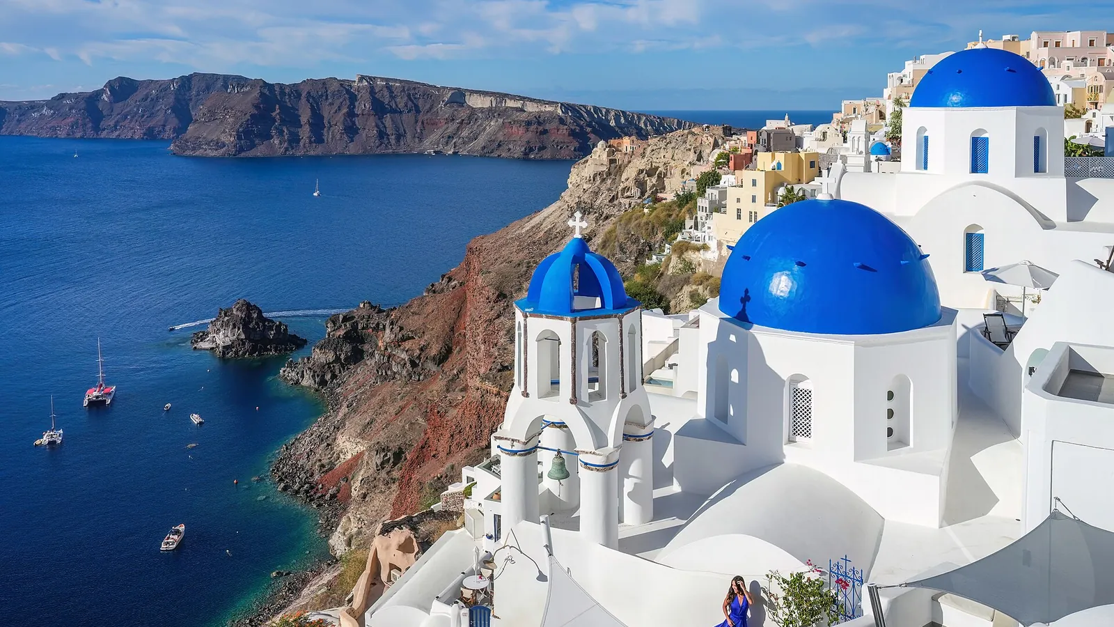 Oia's whitewashed cave houses and blue-domed churches above Santorini's caldera