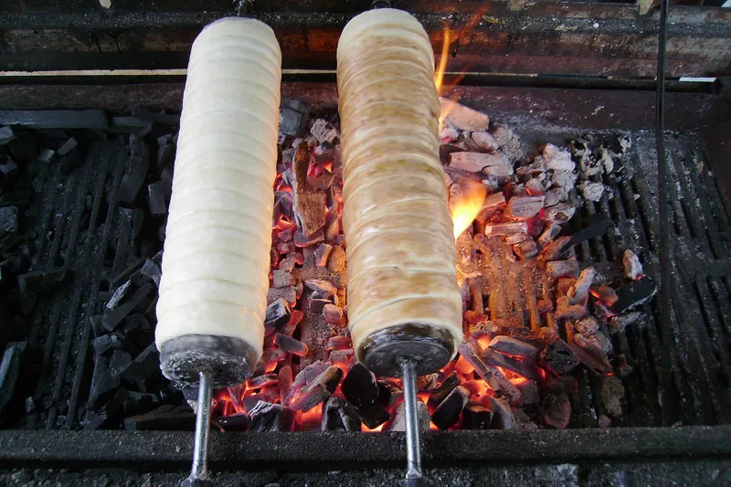 A chimney cake rolled in sugar and baked over coals