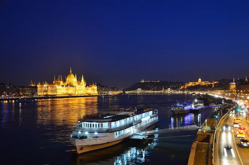 The illuminated Hungarian Parliament Building on the Danube at night