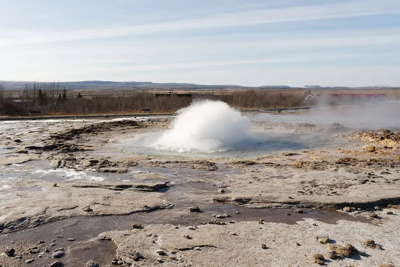 Strokkur geyser erupting in a tall column of water and steam