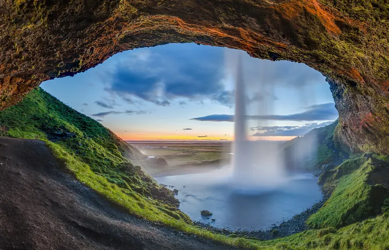 Seljalandsfoss waterfall on Iceland's South Coast, with a path running behind the falling water