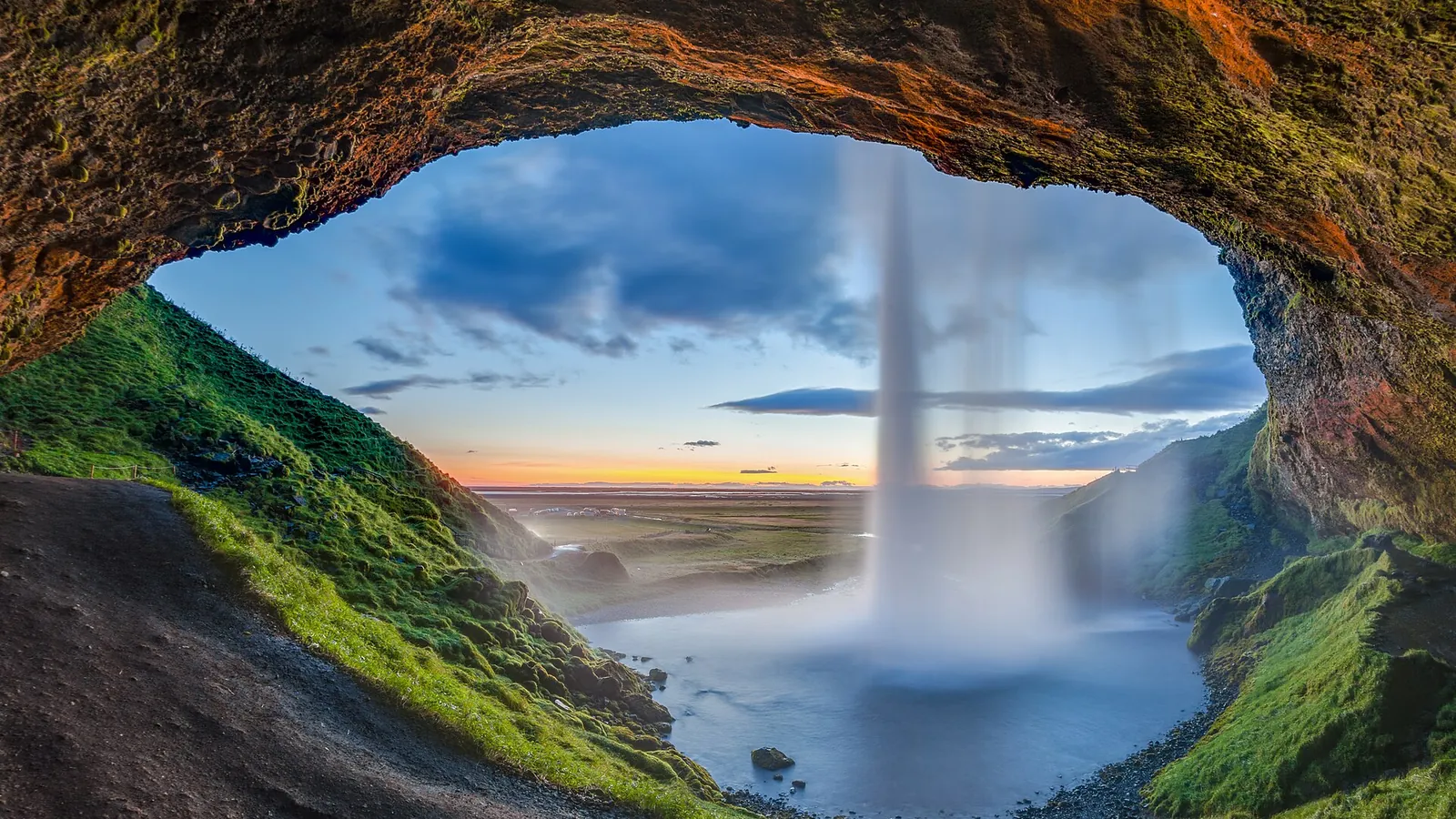 Seljalandsfoss waterfall on Iceland's South Coast, with a path running behind the falling water