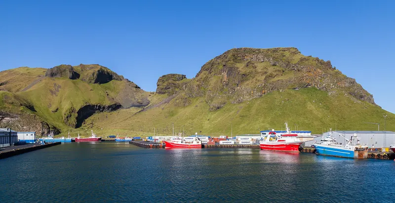 The harbour and town of Heimaey backed by volcanic hills