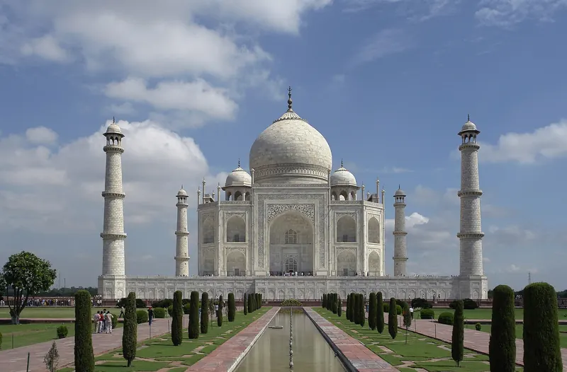 The Taj Mahal in Agra with its white marble dome and minarets reflected in the pool