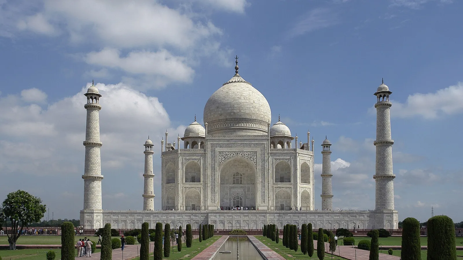 The Taj Mahal in Agra with its white marble dome and minarets reflected in the pool