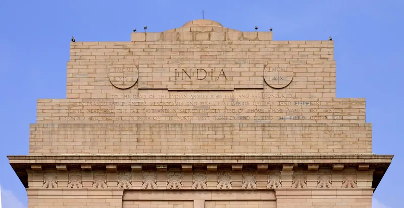 India Gate war memorial in New Delhi at the end of a wide ceremonial avenue