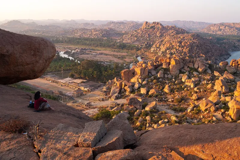 The rocky landscape of Hampi seen from Matanga Hill with granite boulders and green fields