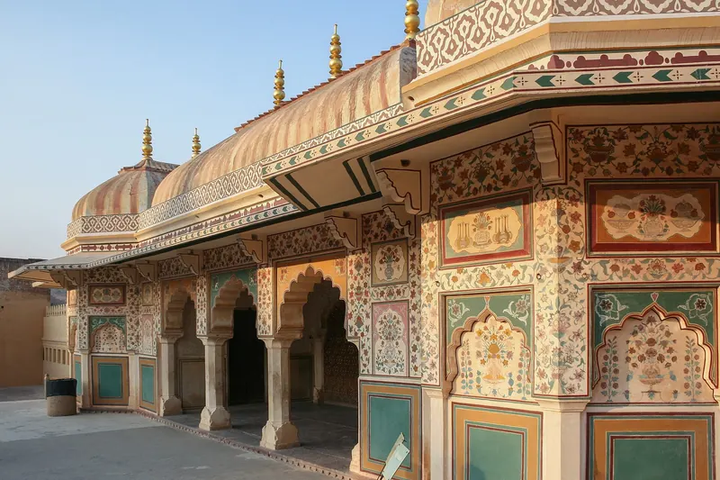 The sandstone ramparts and gateways of Amber Fort above the lake