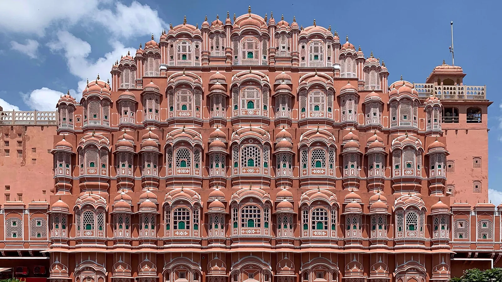 The pink sandstone honeycomb façade of the Hawa Mahal in Jaipur