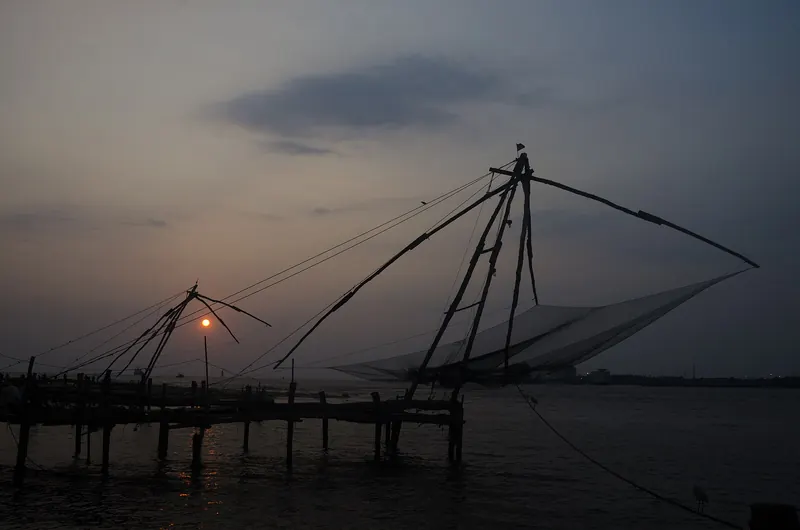 Chinese fishing nets silhouetted at sunset in Fort Kochi