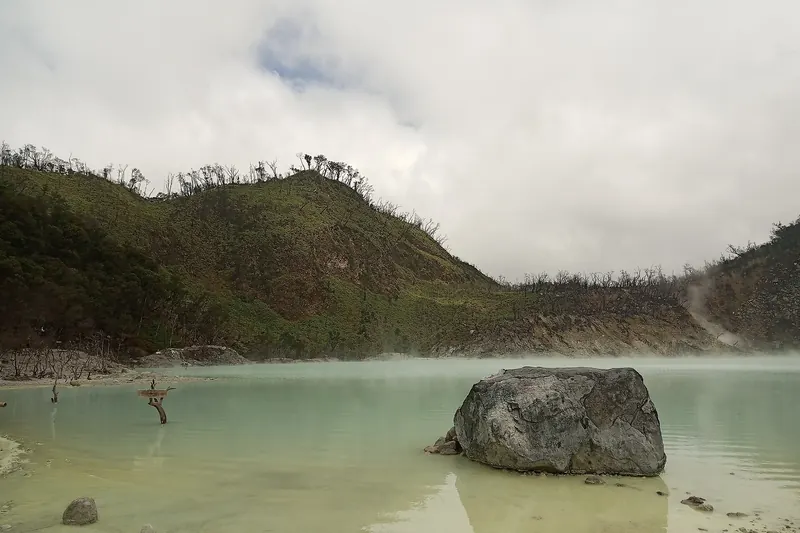 The pale turquoise waters of Kawah Putih crater lake near Bandung