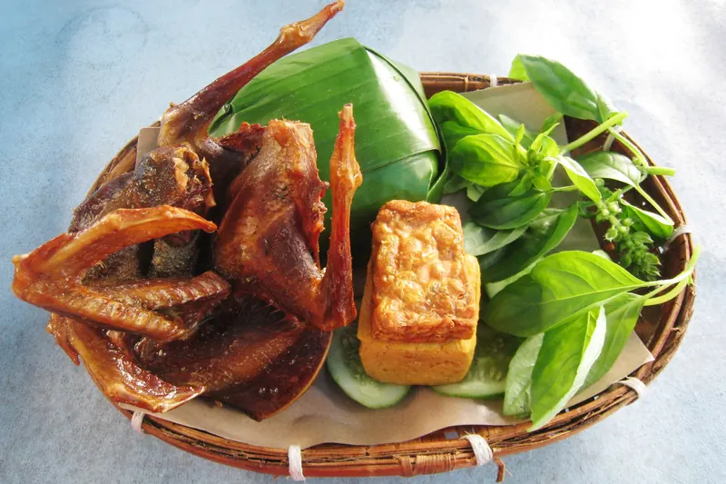 Nasi timbel, rice wrapped in banana leaf, served with fried chicken