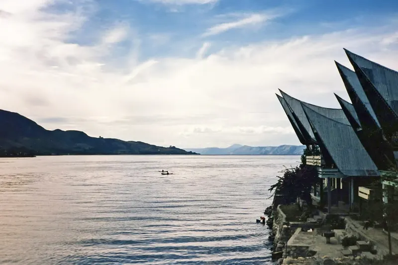 The wide, calm waters of Lake Toba surrounded by highland walls