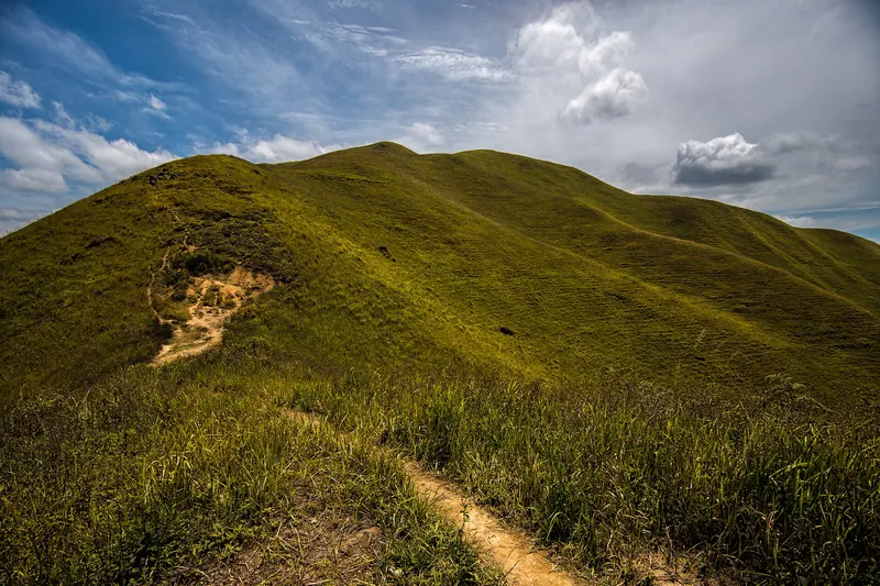 The grassy hilltop viewpoint of Bukit Holbung overlooking Lake Toba