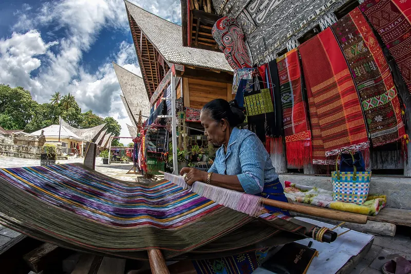 Traditional ulos cloth being woven by hand near Lake Toba
