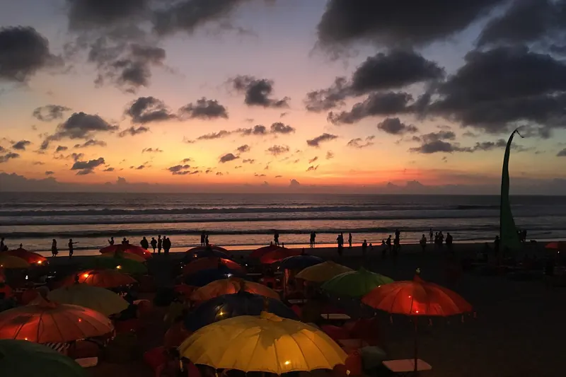 Seminyak Beach at sunset with clouds over the ocean