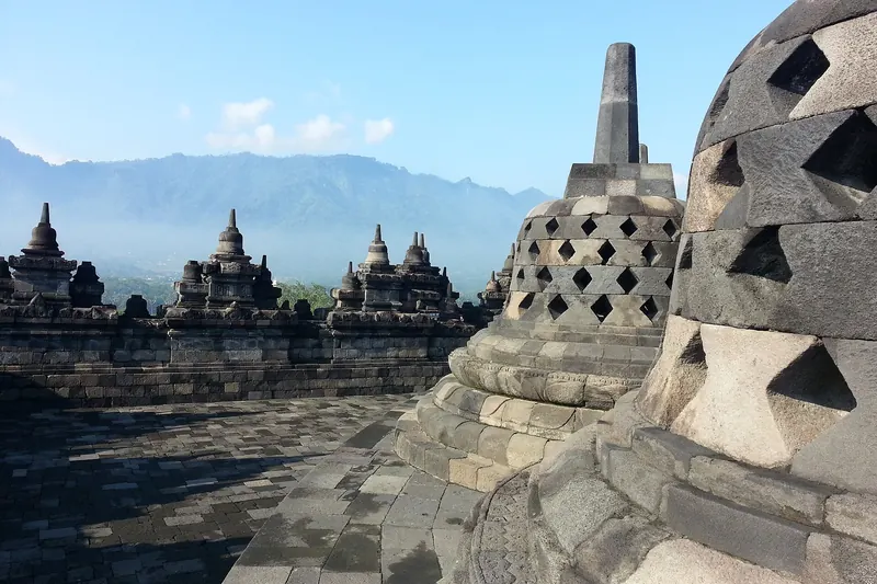 Sunrise light over Borobudur temple's stone terraces