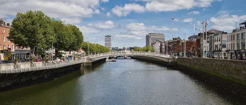 The white cast-iron Ha'penny Bridge over the River Liffey in Dublin