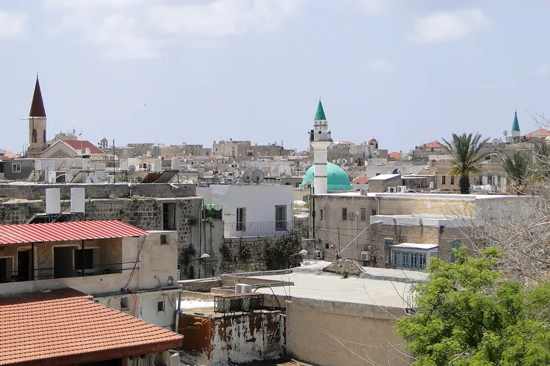 The old city of Acre seen from its sea walls, with the harbour and minarets
