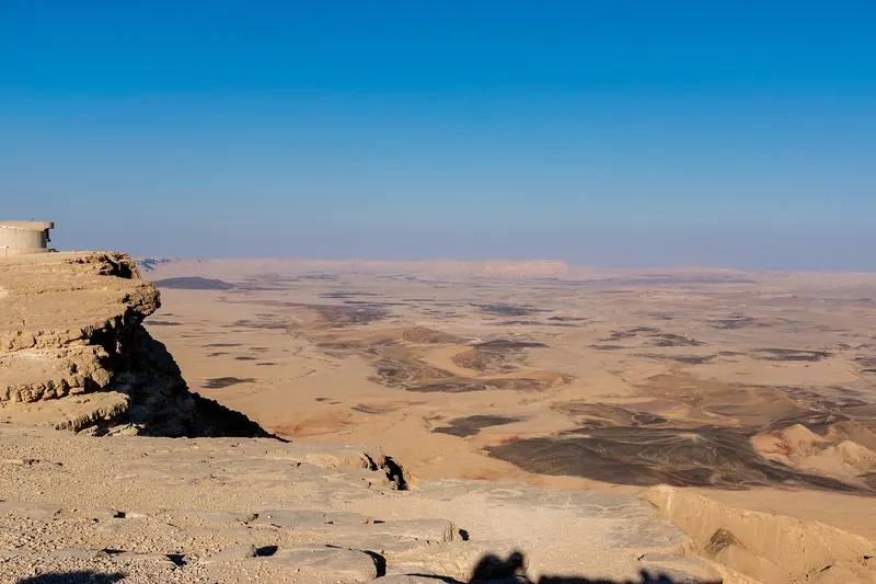 Black rocks and desert cliffs in the Ramon Crater at Mitzpe Ramon