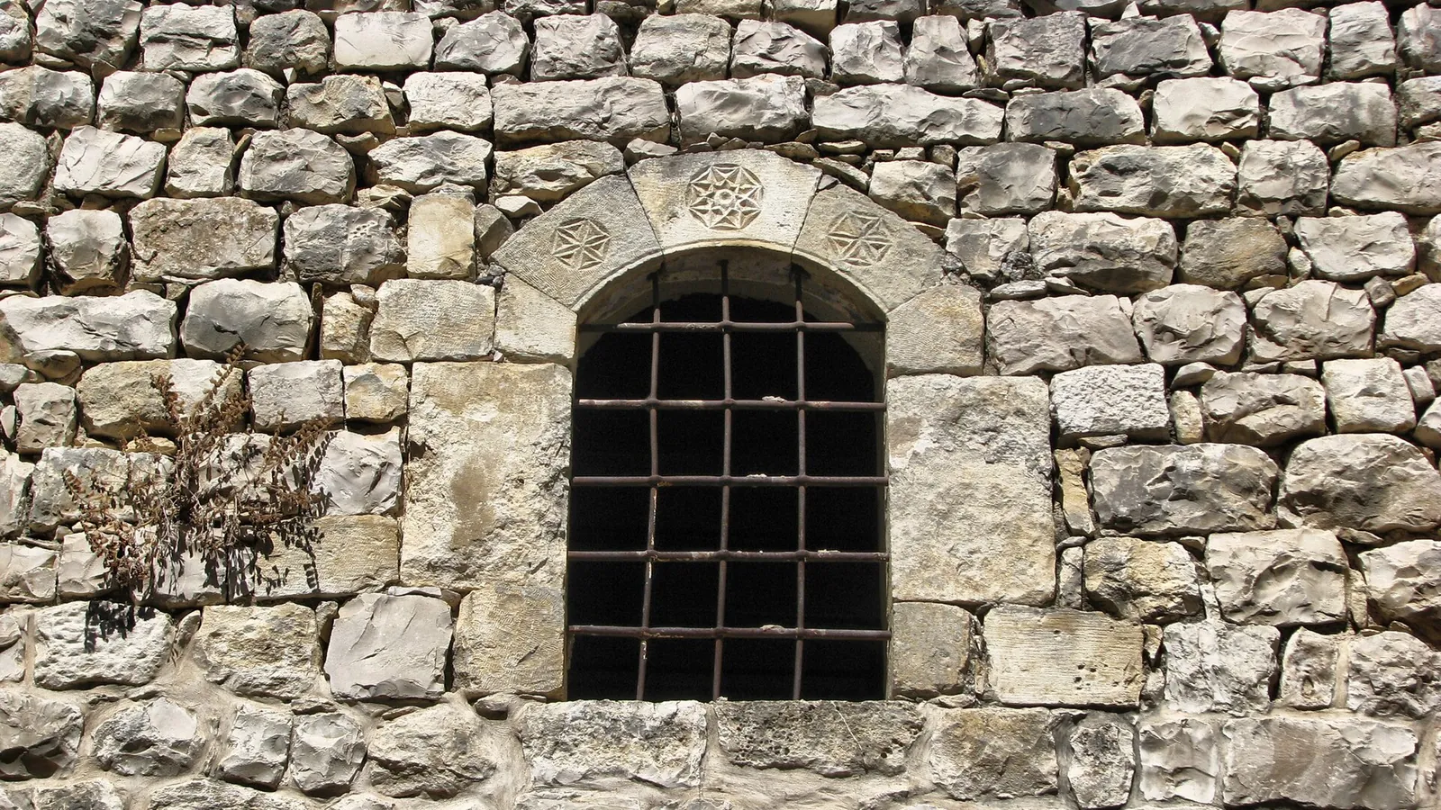 A stone lane in Safed's old city with blue doors and shutters