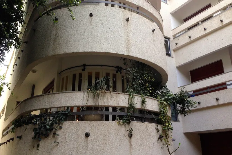 A white Bauhaus apartment building in Tel Aviv