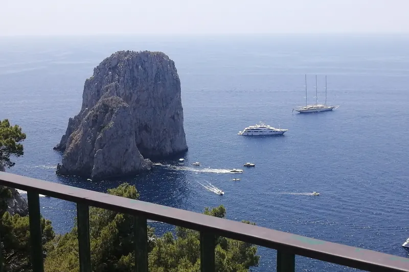 The Faraglioni rock stacks rising from the sea off Capri