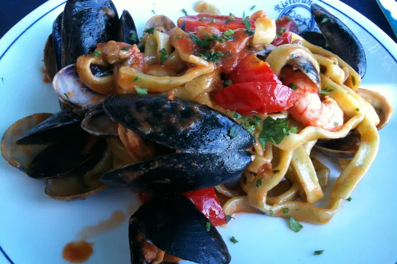 A plate of scialatielli pasta with clams, mussels and prawns