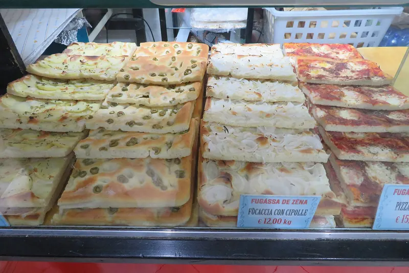 Ligurian focaccia, thin, salty and dimpled with oil, sold by weight
