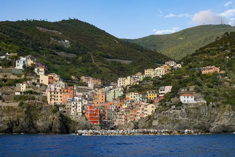 Riomaggiore seen from a ferry passing along the coast